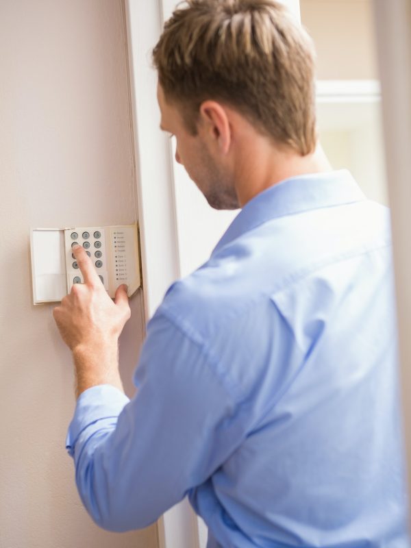 man-arming-a-home-alarm-on-the-wall.jpg